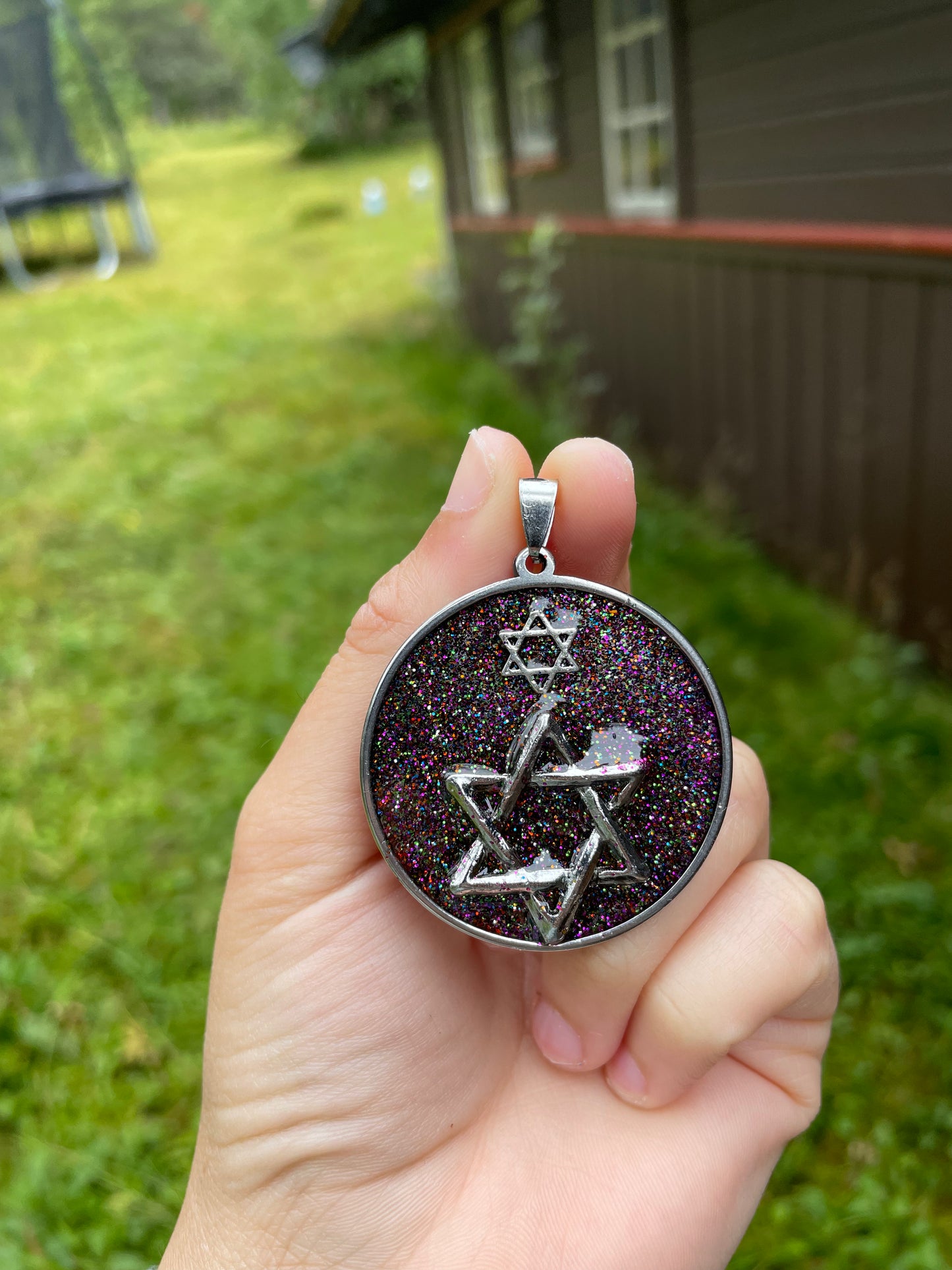 Far Galaxies: Double Magen David Glittery Resin Pendant set in round Stainless Steel Frame