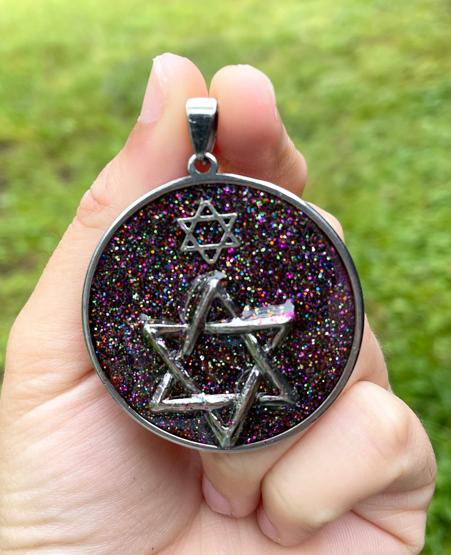 Far Galaxies: Double Magen David Glittery Resin Pendant set in round Stainless Steel Frame