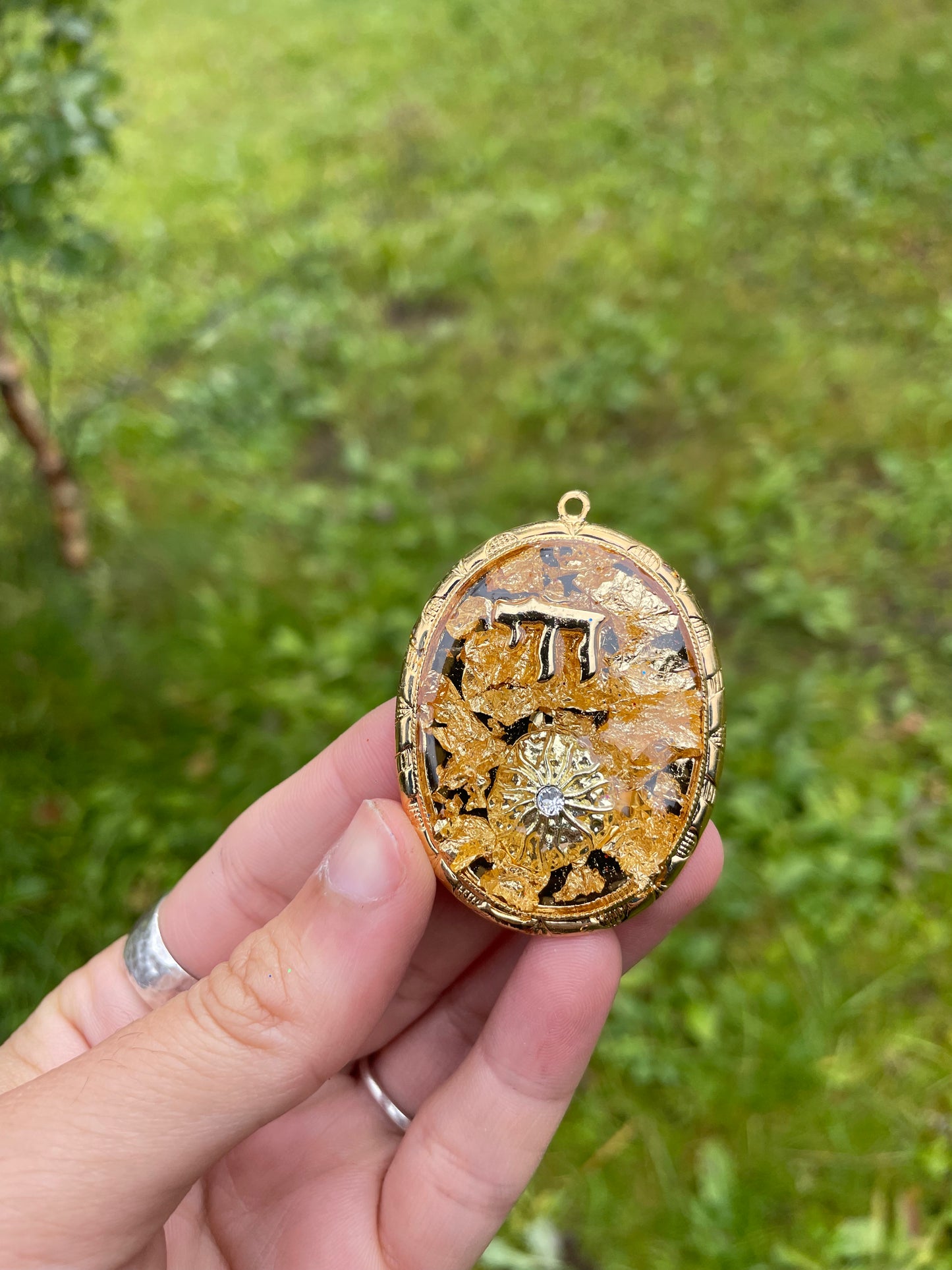 Chai & Sunny Rays pendant with Gold Flakes, Chai and Sun charms in Gold plated Oval Frame