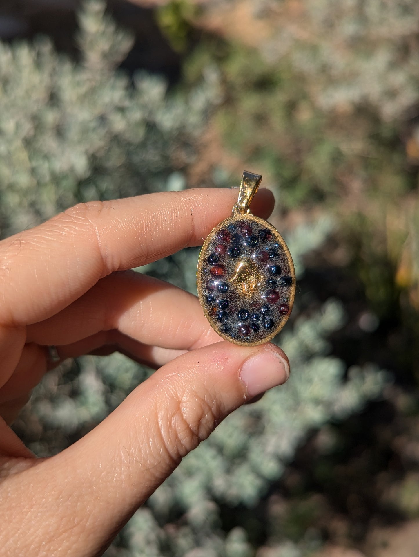 Gold Plated Hamsa, Garnet Gemstones and Blue Glass Beads Resin Pendant