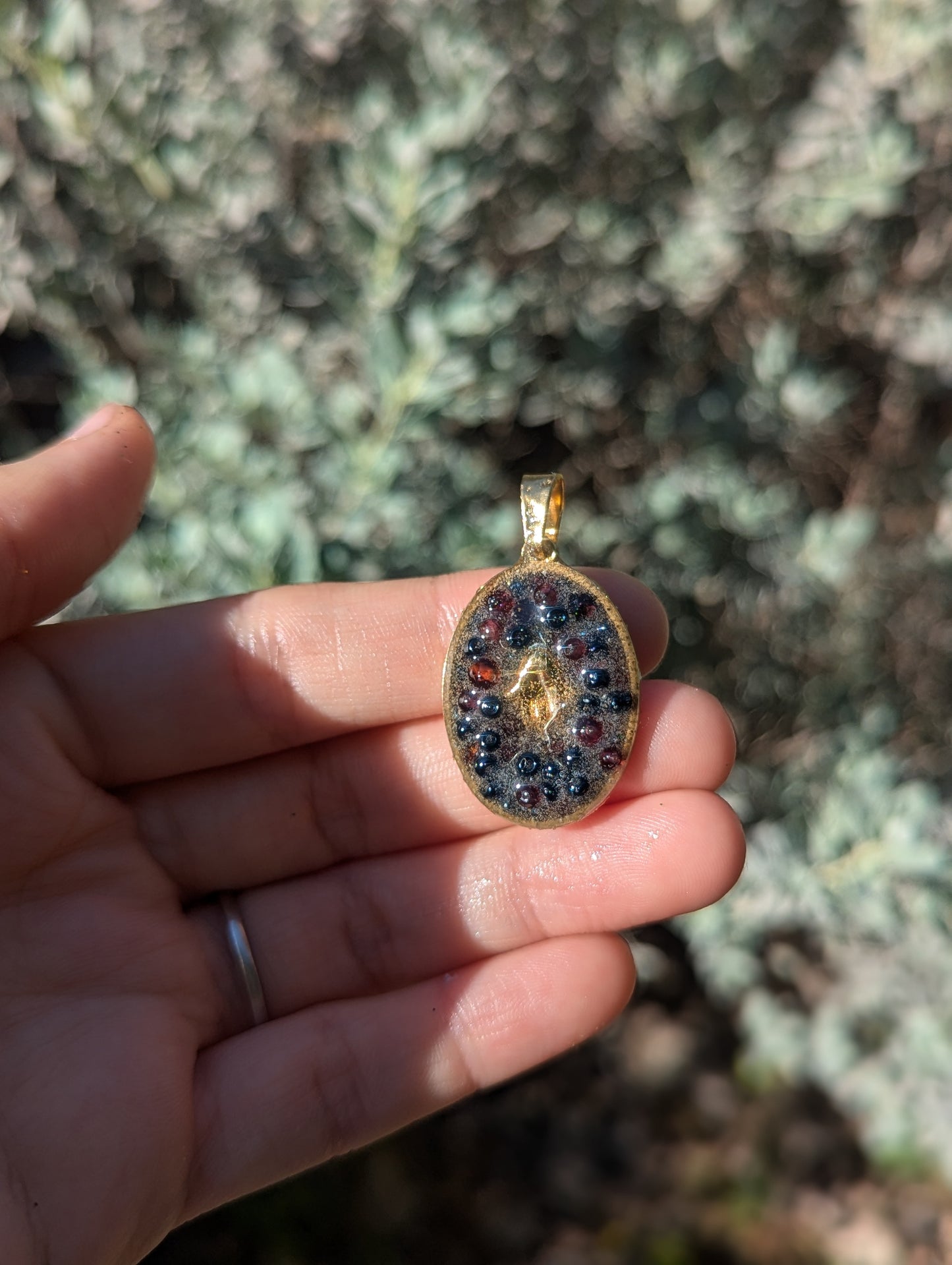 Gold Plated Hamsa, Garnet Gemstones and Blue Glass Beads Resin Pendant