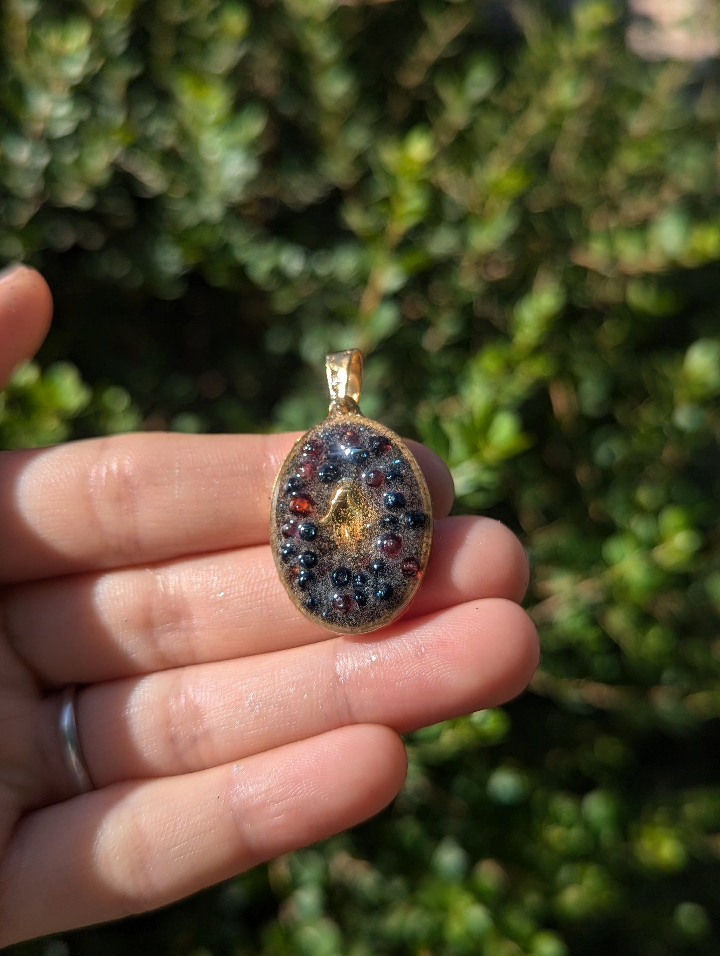 Gold Plated Hamsa, Garnet Gemstones and Blue Glass Beads Resin Pendant