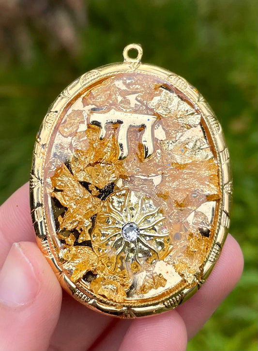Chai & Sunny Rays pendant with Gold Flakes, Chai and Sun charms in Gold plated Oval Frame