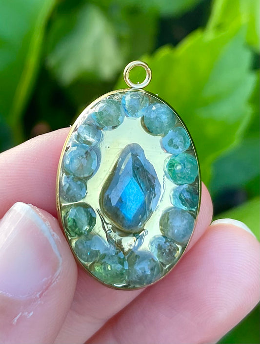 Magic Encapsulated: Labradorite and Kyanite Gemstones in Gold Plated Oval Resin Pendant