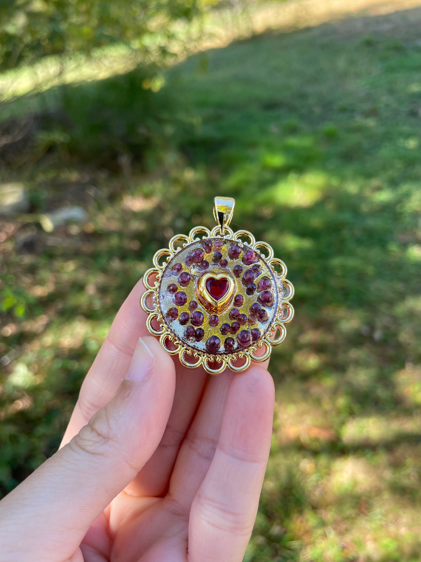 Heart of Garnet Gemstones, Resin, Red Zirconia and Gold Plated Round Decorated Frame