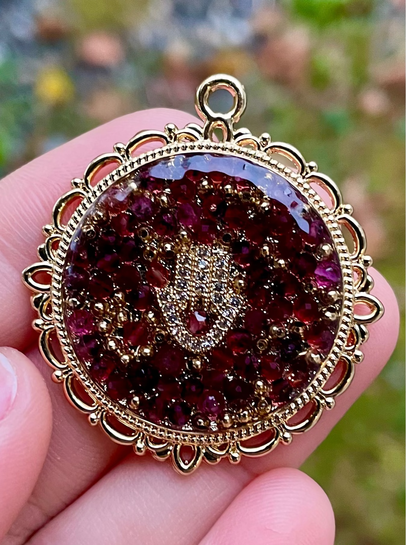 Anava: Garnet Gemstones Gold Plated Hamsa Round Decorated Resin Pendant