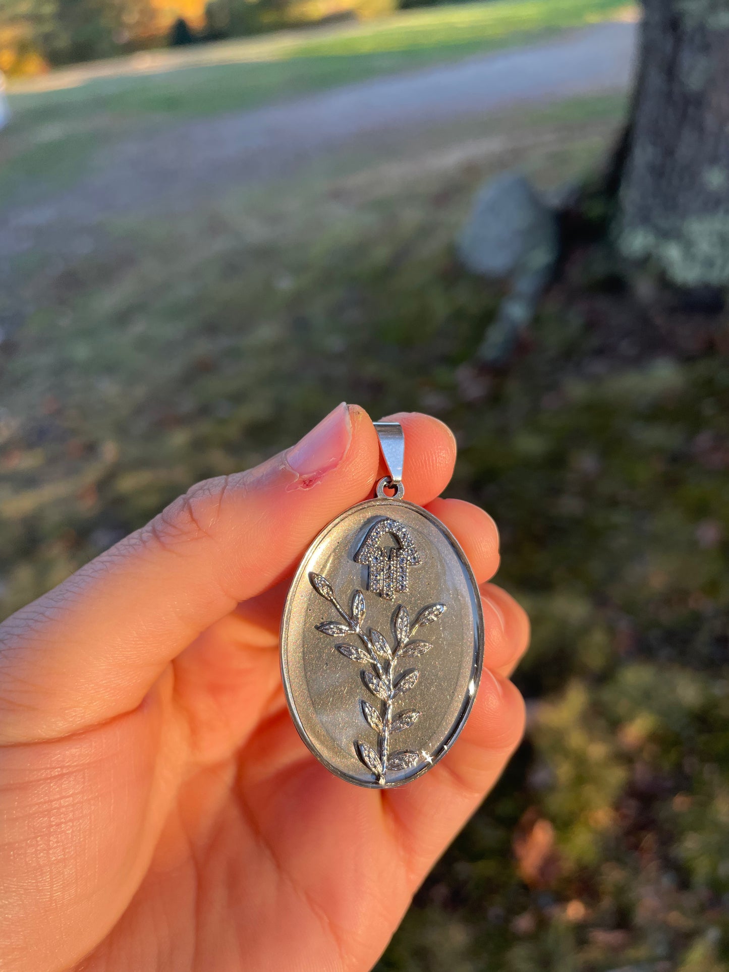 Zirconia Hamsa and Silver leaves Resin Oval Stainless Pendant