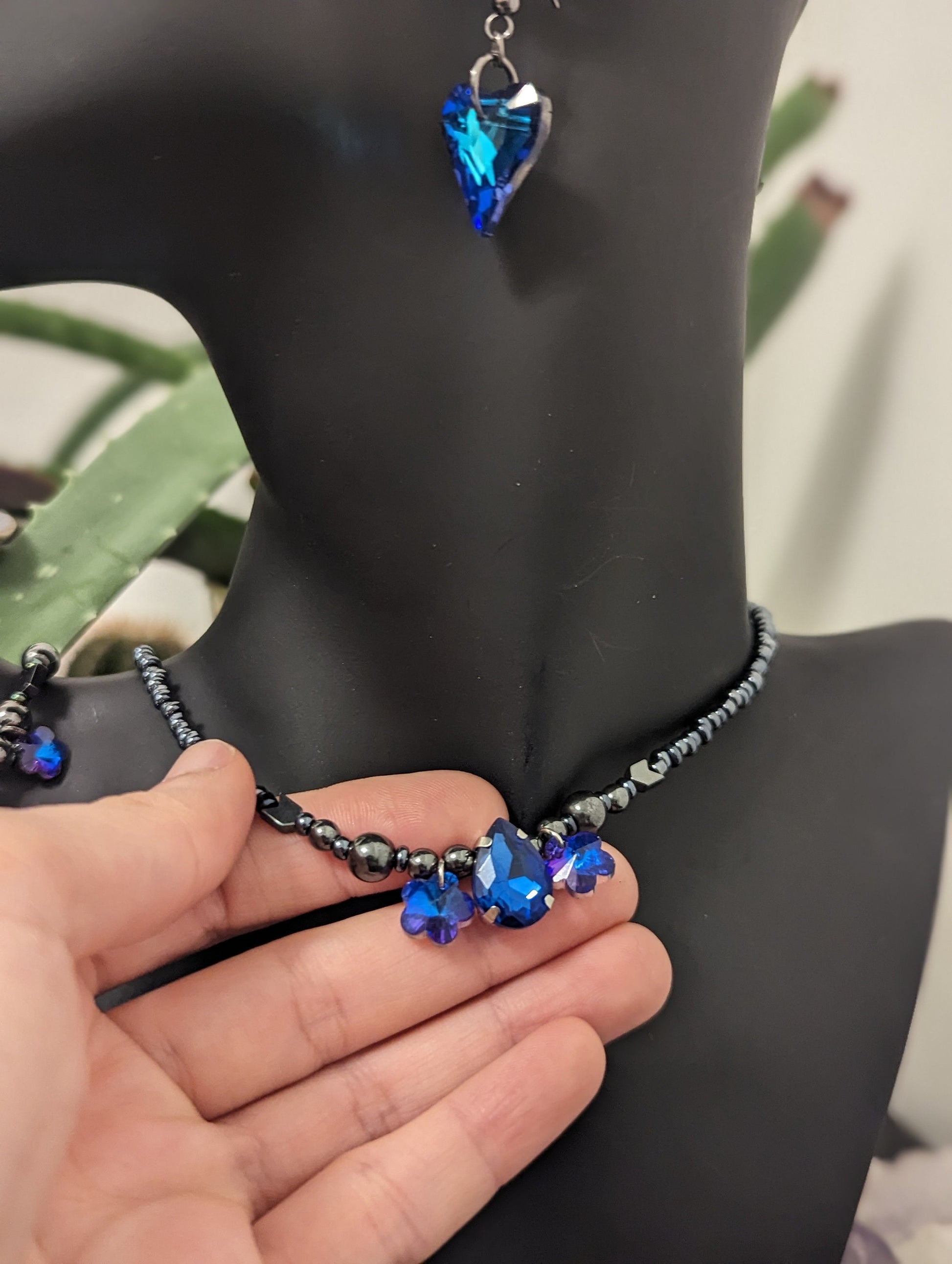 ISRAEL Water for Flowers: Blue Drop Pendant, 2 Purple Flower Pendants, Hematite Styled Arrow Beads and Dark Blue Glass Beads