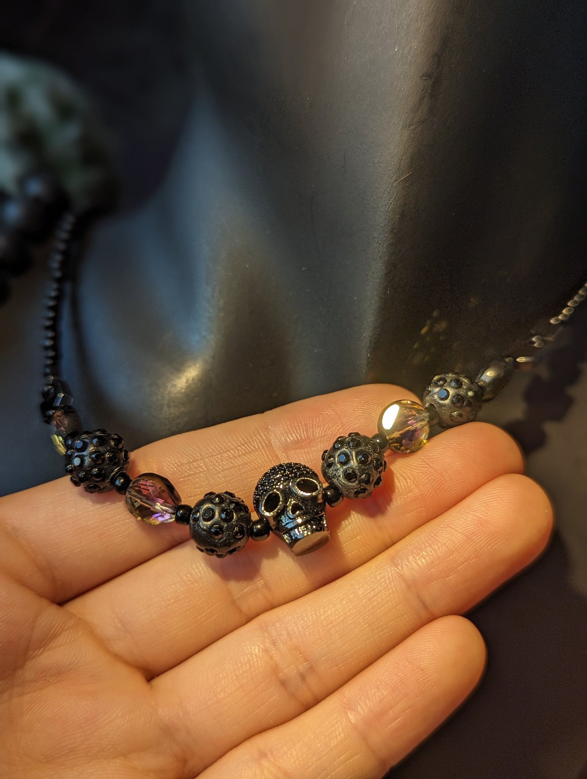 Skulls Set: Shimmering Skull Pendant, Purple Black Glass Beads, Shimmering Black Beads, Silver Skull Earrings and Orange Eyes Skull Bracelet