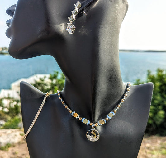 BERMUDA Gold Dolphin Set: gold dolphin and silver zircon round pendant with white zircon waves, gold and silver geometric beaded necklace