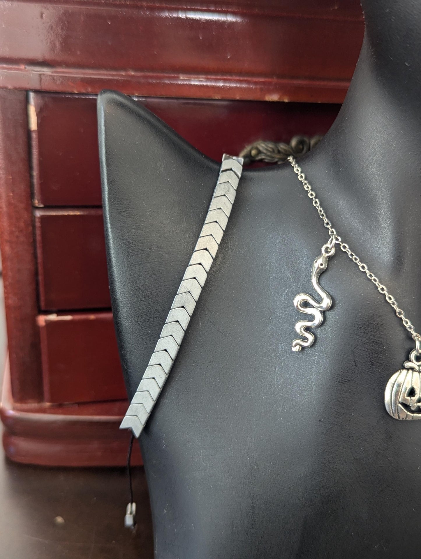 Silver Halloween Set. Made with silver snake, moon and jack-o'-lantern pendants on a silvery chain, silver grey bracelet and skull earrings