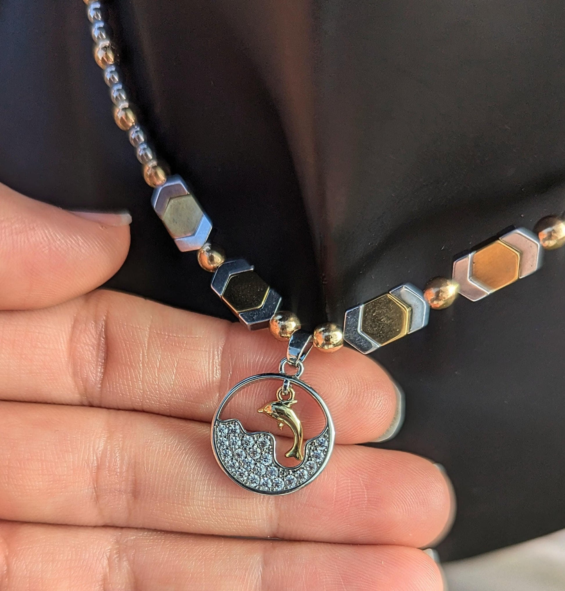 BERMUDA Gold Dolphin Set: gold dolphin and silver zircon round pendant with white zircon waves, gold and silver geometric beaded necklace